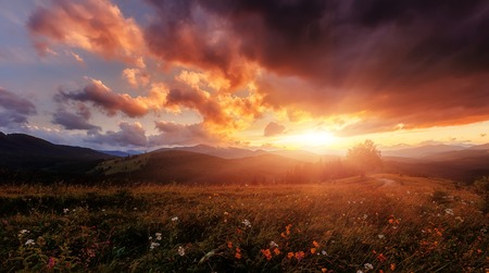 Majestic Sunset with colorful clouds on overcast sky. Unsurpassed sunrise in the mountains. Picturesque Dramatic scene. Creative image. Nature Landscape.の写真素材