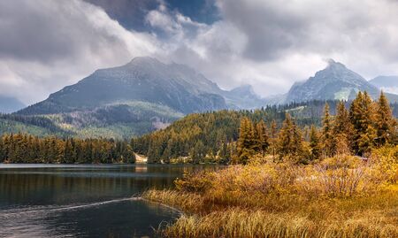 Scenic image of fairy-tale Landscape with colorful overcast sky under sunlit, over the Mountain Lake. Megical Natural Background. Amazing lake in sunny day. Creative image.の写真素材