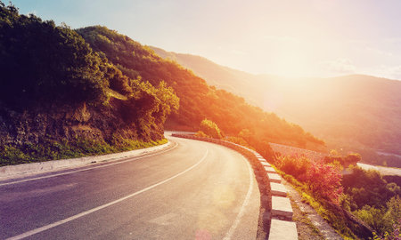 mountain road. beautiful road asphalt in the evening in summer during sunset. vintage toning. travel...