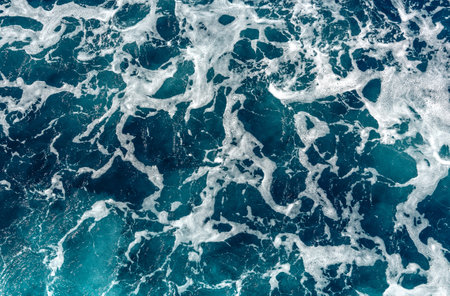 ocean with blue water on a sunny day. clear sea water surface. blue sea water texture. natural patterns. used as background.の写真素材