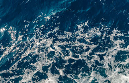 Background shot of aqua sea water surface. Abstract texture of nature. Rapid sea while sailing ship.の写真素材