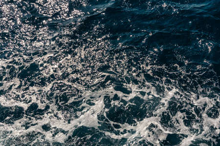 ocean with blue water on a sunny day. clear sea water surface. blue sea water texture. natural patterns. used as background.の写真素材