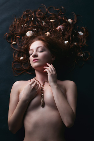 groomed perfectly girl lying with closed eyesの写真素材