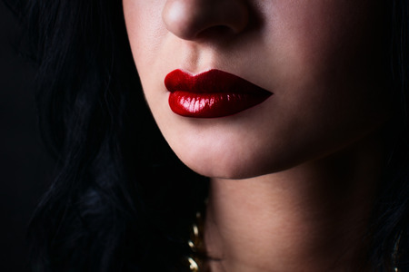 red lips brunette, on a black backgroundの写真素材