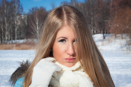 Girl on the background of the forest. Cold weather outsideの写真素材