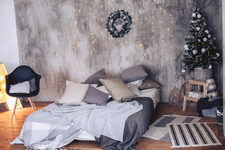 Christmas modern interior in a loft with New Year decor. Christmas tree in decorationsの写真素材