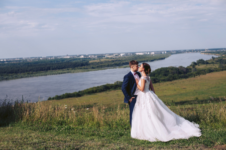 Young couple kissing outdoors on their wedding dayの写真素材