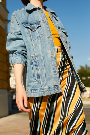 Denim blue jacket on the girl in the image in yellow colors. Street styleの写真素材