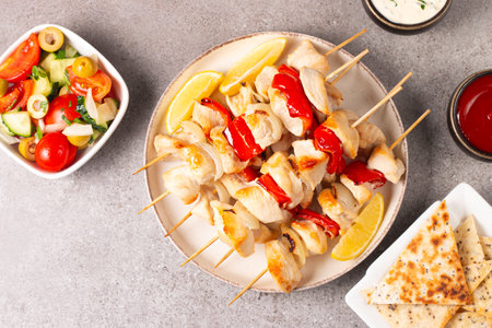 Chicken kebab on skewers with vegetables and sauces. Selective focus.の写真素材