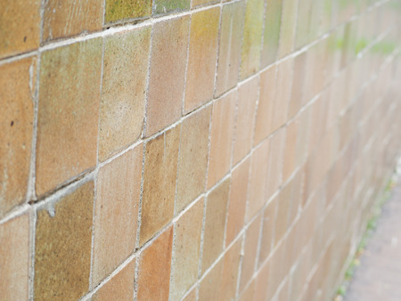 Old brick wall, old texture of brown stone blocks background.の写真素材