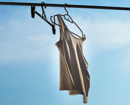 focus one white cloth with one Hanger and sky background.の写真素材