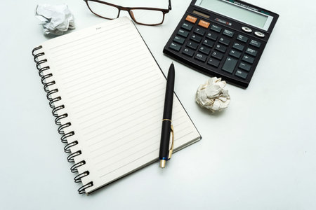 Top view white clean office table, White blank spiral notebook and pen for notes with copy space