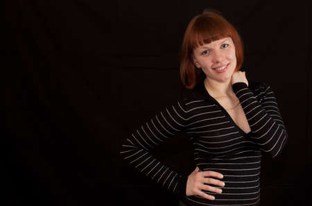 a young adult woman wearing a striped sweaterの写真素材