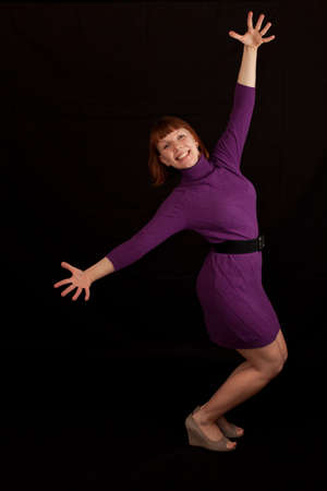 a young adult woman with arms widely stretchedの写真素材