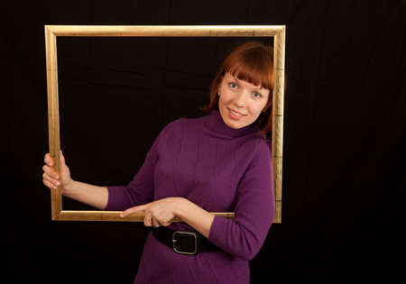 a young adult womand leaning in a picture frameの写真素材