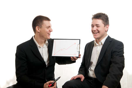 a young businessman presenting a chart while other smilesの写真素材