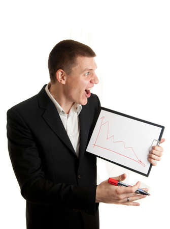 a young businessman showing chart indicating decline while angrykの写真素材