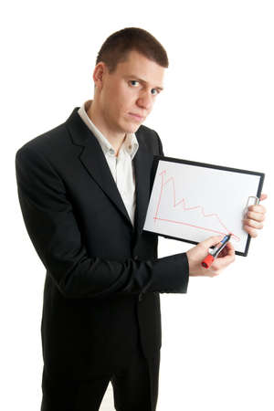 a young businessman showing chart indicating declineの写真素材