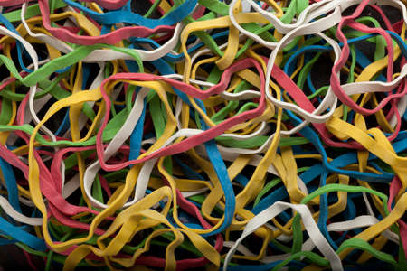 some colored rubberbands forming a background patternの写真素材