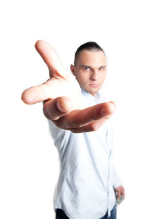 a young man stetching his hand to the camera offering helpの写真素材