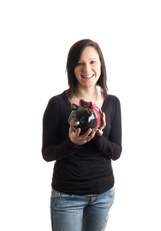 a young woman holding a piggy bank isolated on whiteの写真素材