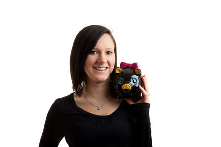 a young woman with a piggy bank on her shoulder isolated on whiteの写真素材