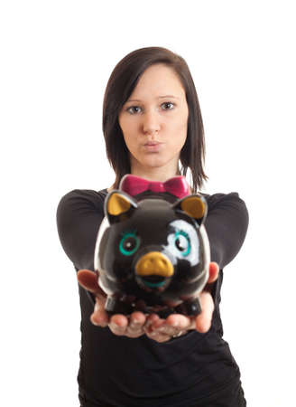 closeup of a young woman presenting a piggy bank to the cameraの写真素材