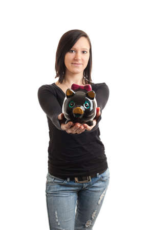 a young woman presenting a piggy bank to the cameraの写真素材