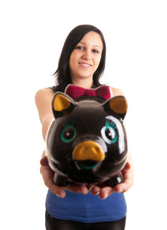 a young woman presenting a piggy bank to the cameraの写真素材