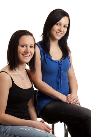 two young women posing isolated on whiteの写真素材