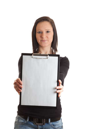 a young woman holding a clipboard with an empty sheet of paper in front of her isolated on whiteの写真素材