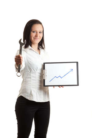 a young woman holding a chart indicatin growth and a wrenchの写真素材