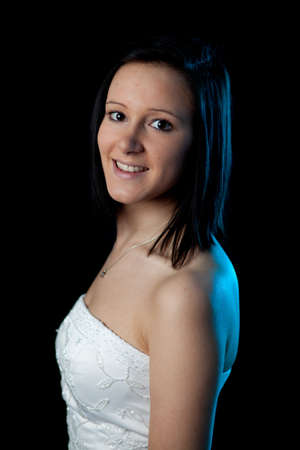 portrait of a young woman in a dress with blue backlightの写真素材