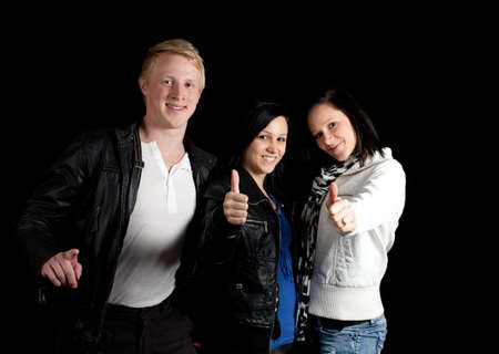 a small group of young people posing with thumbs upの写真素材