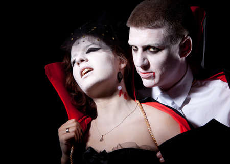 a vampire biting a young woman from behindの写真素材