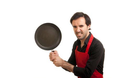 a crazy chef holding a pan like a weaponの写真素材