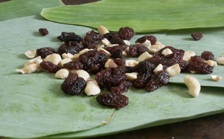 Pile of mixing between cashew and raisinの写真素材