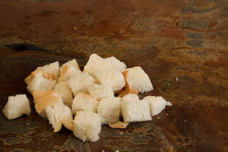 Many piece of bread and crump on the wood backgroundの写真素材