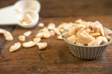 A pile of cashew in the cupcake mold show on the right prepared to make bakery with the another cashew decoratedの写真素材