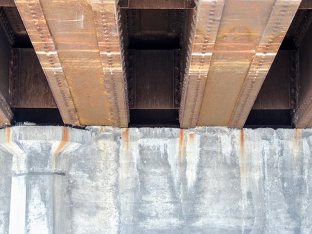 Steel beams on concrete rusting view under car road bridge in Indianapolis Indiana.の写真素材