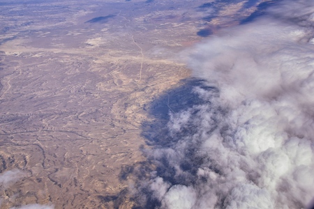 Aerial Cloudscape view over midwest states on flight over Colorado, Kansas, Missouri, Illinois, Indiana, Ohio and West Virginia during autumn. Grand sweeping views of landscape and clouds. Views of crops, rivers, plains, mountain and cloud patterns. Top view texture of clouds, USA.の写真素材