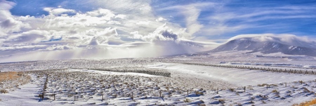 Wyoming countryside panoramic views during a blizzard with mountain with snow covered with overcast grey cloudy sky. Wyoming, United States.の写真素材
