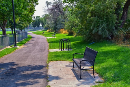 Views of Jordan River Trail with surrounding trees, Russian Olive, cottonwood and silt filled muddy water along the Wasatch Front Rocky Mountains, in Salt Lake City, Utah.の写真素材