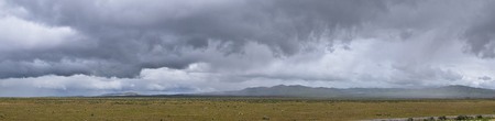 Landscape stormy panorama view from the border of Utah and Idaho from Interstate 84, I-84, view of rural farming with sheep and cow grazing land in the Rocky Mountains. United States.の写真素材