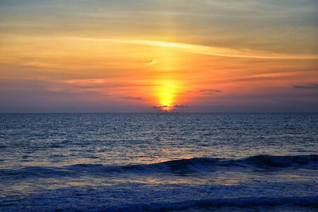 Phuket beach sunset, colorful cloudy twilight sky reflecting on the sand gazing at the Indian Ocean, Thailand, Asia.の写真素材