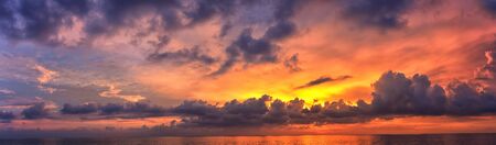 Phuket beach sunset, colorful cloudy twilight sky reflecting on the sand gazing at the Indian Ocean, Thailand, Asia.の写真素材