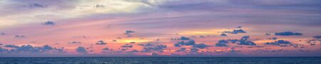 Phuket beach sunset, colorful cloudy twilight sky reflecting on the sand gazing at the Indian Ocean, Thailand, Asia.の写真素材