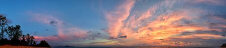Phuket beach sunset, colorful cloudy twilight sky reflecting on the sand gazing at the Indian Ocean, Thailand, Asia.の写真素材