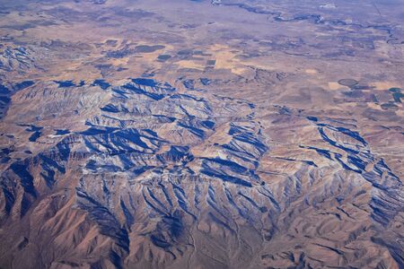 Colorado Rocky Mountains Aerial view from airplane of abstract Landscapes, peaks, canyons and rural cities in southwest Colorado and Utah. United States of America. USA.の写真素材