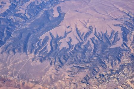 Colorado Rocky Mountains Aerial view from airplane of abstract Landscapes, peaks, canyons and rural cities in southwest Colorado and Utah. United States of America. USA.の写真素材